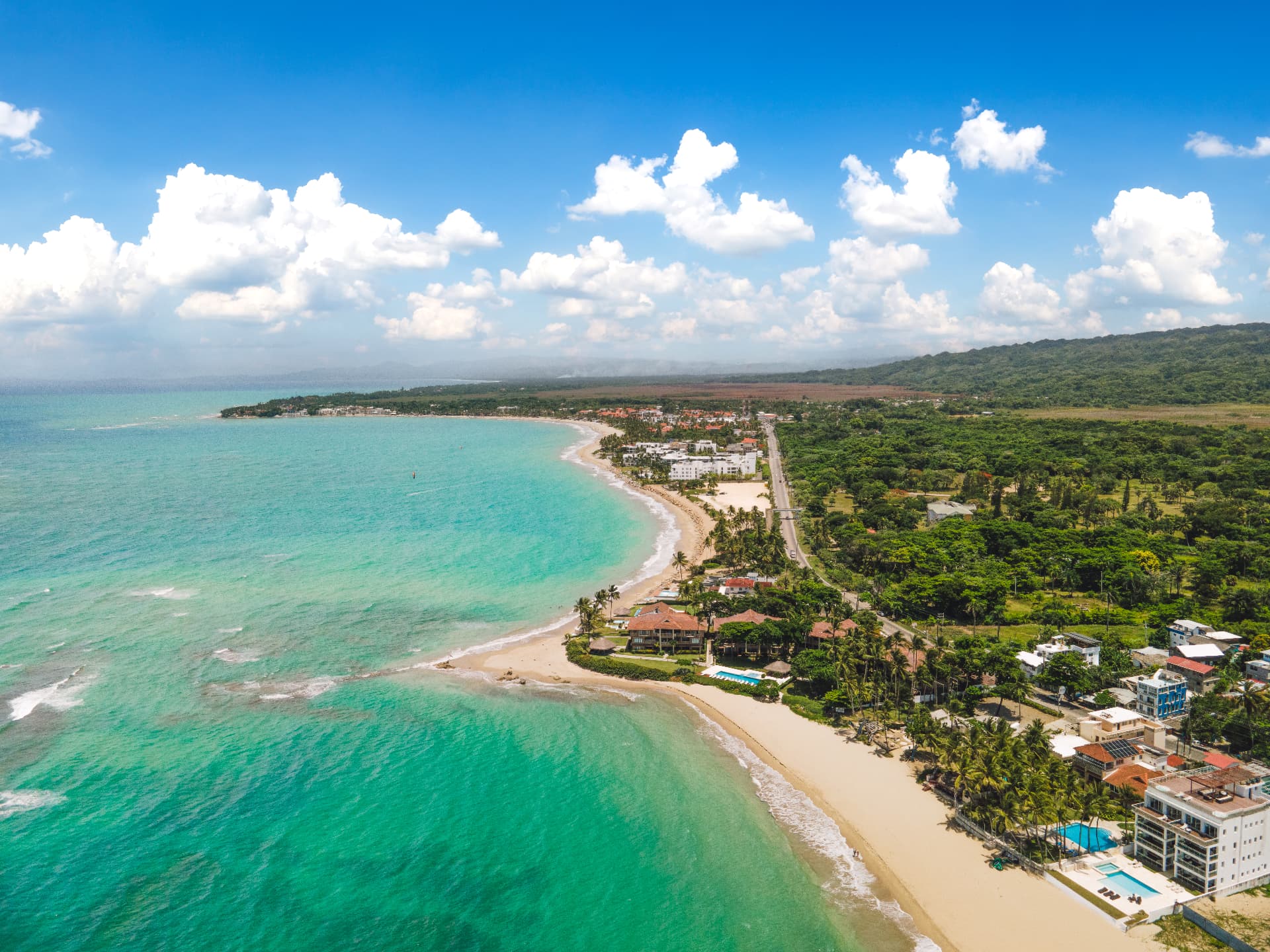 Aerial view of the bay at Cabarete, turquoise water curving along the sand